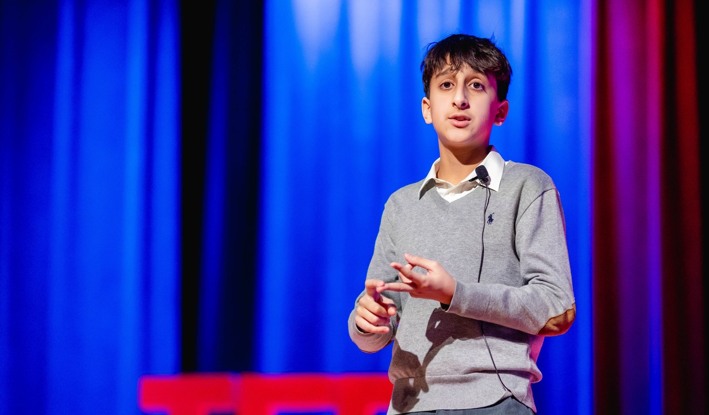 An Orblynx student speaking on stage at a TEDx event