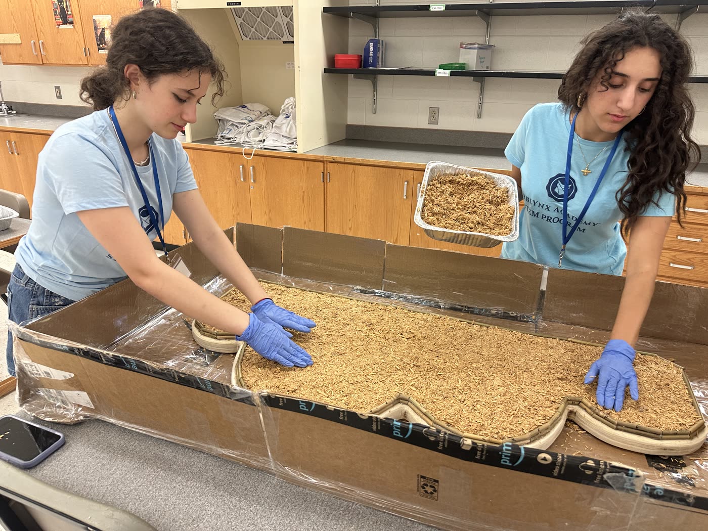 Students packing mycelium substrate into a bench mold