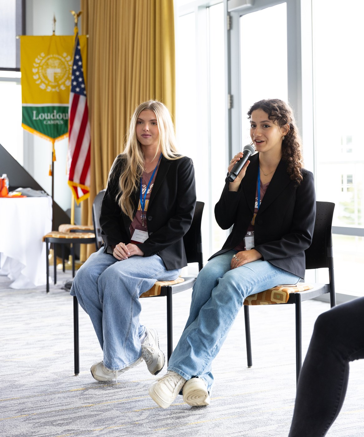 Two Orblynx students speaking on a panel at a Loudoun community event