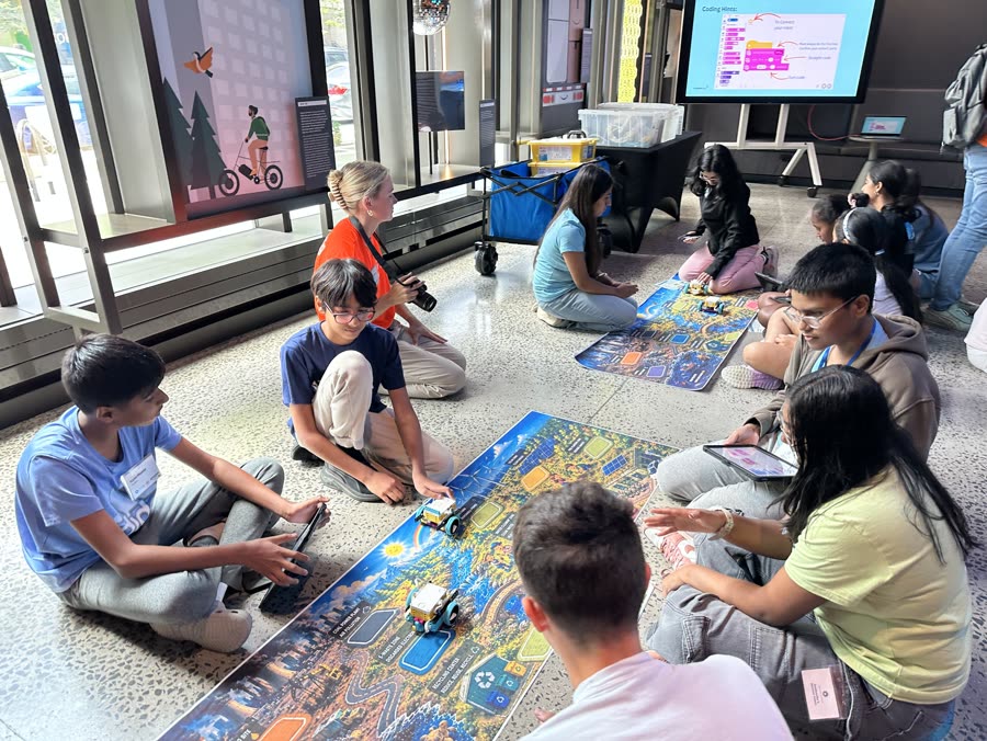 Students programming robots on a city map