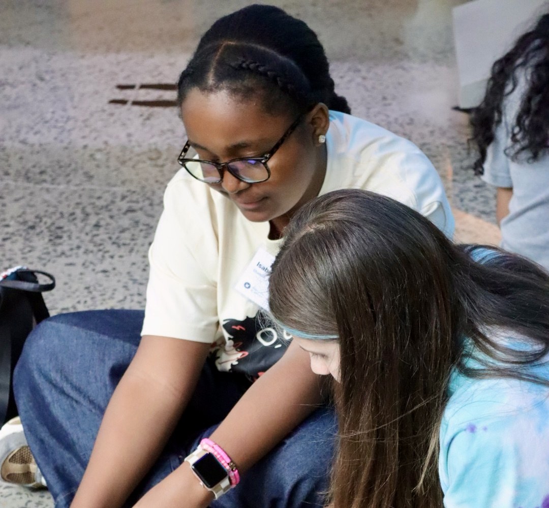 Two STEM for Girls students working together on a floor-map robotics challenge