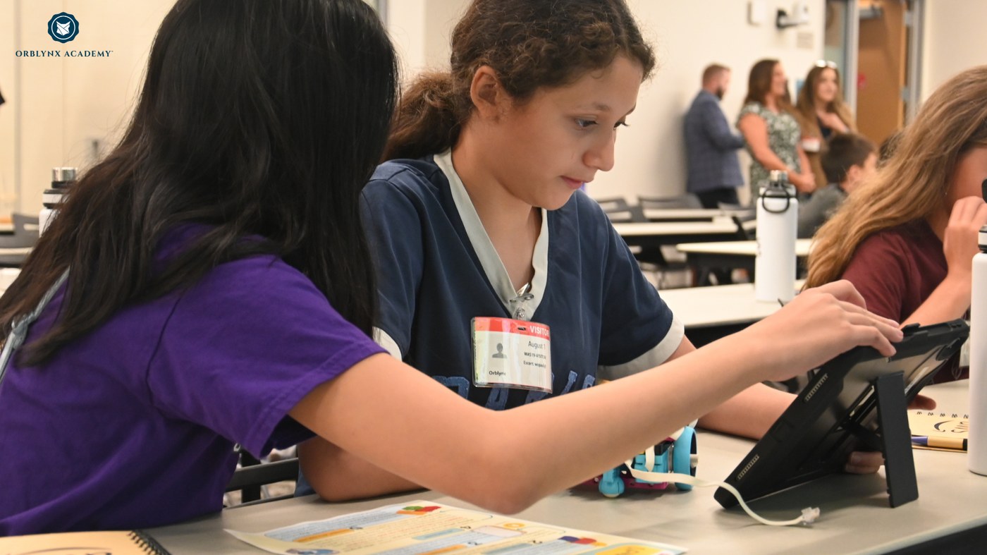 STEM for Girls students working through a project on tablets in the lab
