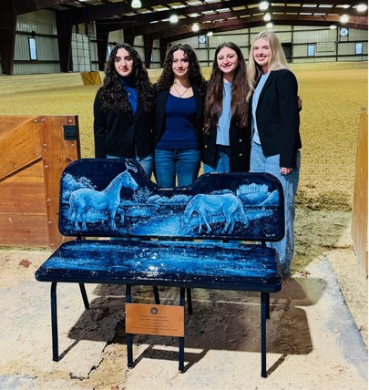 Four Orblynx students with their painted BioBench installed at the equestrian centre